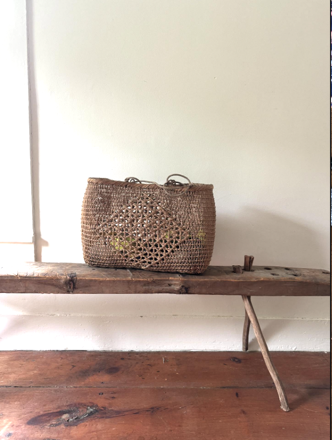 antique table with woven bag