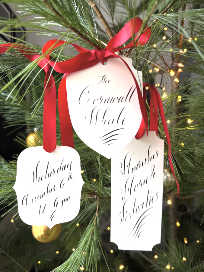 labels on xmas tree cornwall whale in calligraphy