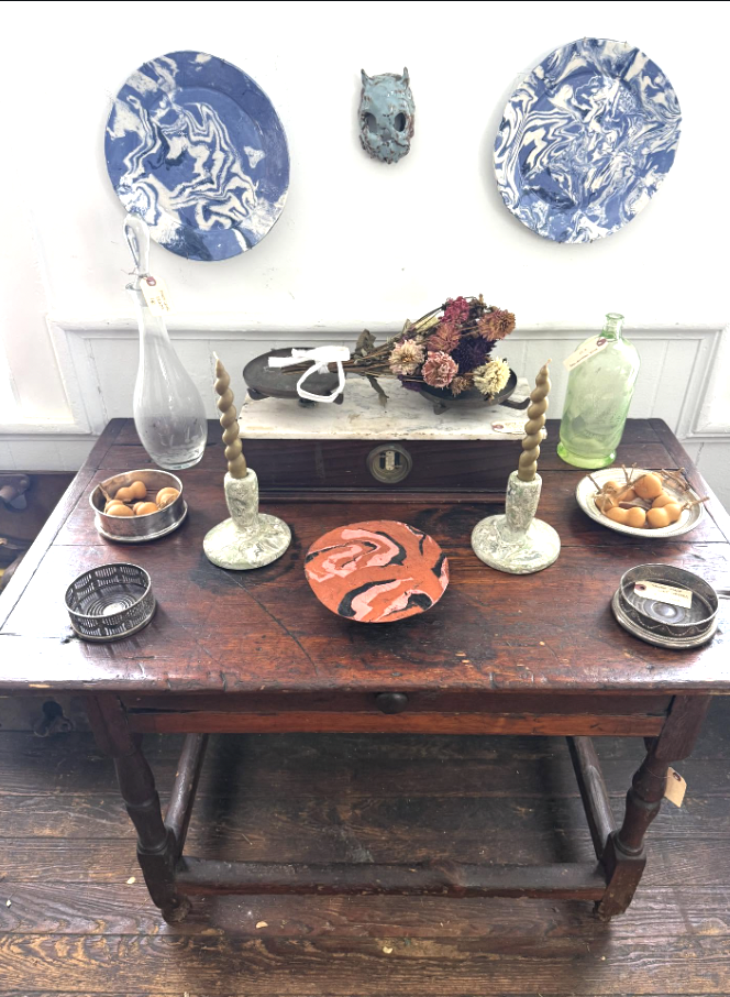 display of cermaics, candlesticks, bottles, fruit